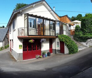 Stunning two-story building with a spacious balcony and lush garden area.