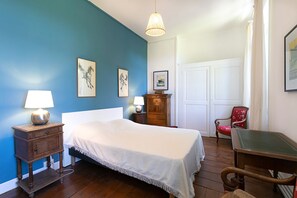 A bedroom with a bed, bedside tables, a chair, a desk, and a wardrobe. - Chateau in magnificent park with swimming pool (Thuir)