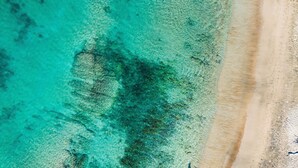 A beach with clear turquoise water and a sandy shoreline. - SUMMER SALE! 2BD OceanFront Getaway w AC Pool - Lauloa 105 (Wailuku)