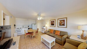A compact living space with a kitchenette, a dining area, and a seating area with a sofa and chairs. - Resort Sixty-Six - 1 Bedroom (Holmes Beach)