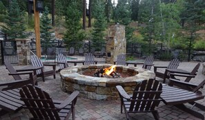 Relax in the inviting outdoor seating area with a fire pit and Adirondack chairs.