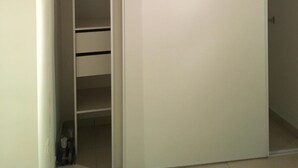 A room with a sliding closet door, a built-in shelving unit, and a visible door handle. - Detached house (Large private garden) (Petreto-Bicchisano)