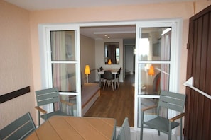 Une pièce comprenant une table et des chaises en bois, un canapé et un coin repas avec une table et des chaises.