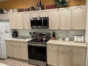 Enjoy cooking in this well-equipped kitchen with a microwave, oven, toaster, and coffee maker.