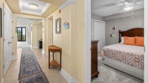 Quarto de hotel com cama, ventilador de teto, mesa de cabeceira e vista para o exterior.
