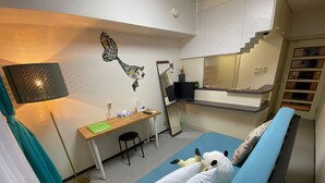 A compact room with a bed, a desk, a chair, a lamp, a mirror, and a TV. - Today's Relaxing and Fun Studio! Near Olympic Park! (Setagaya)