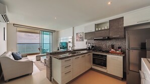 A modern kitchen with granite countertops, stainless steel appliances, and a large island. - Spacious & Luxury apt in Bocagrande in Palmetto Beach (Cartagena)