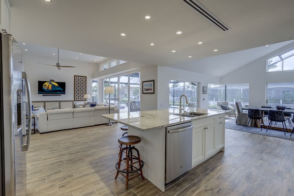 Enjoy cooking and socializing in this spacious kitchen with a large island, dishwasher, and comfortable seating area.
