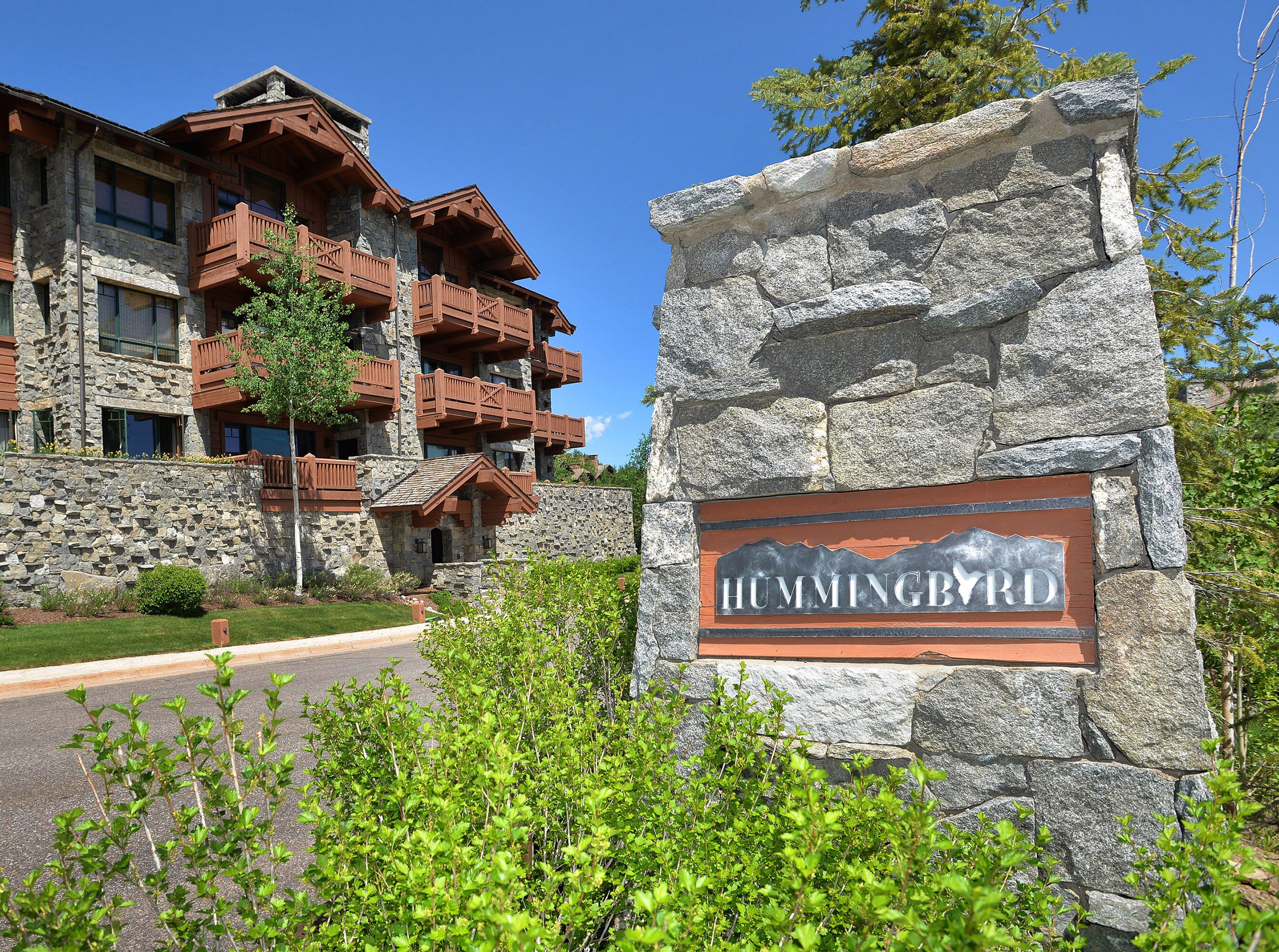 A stone building with a sign reading "HUMMINGBIRD".