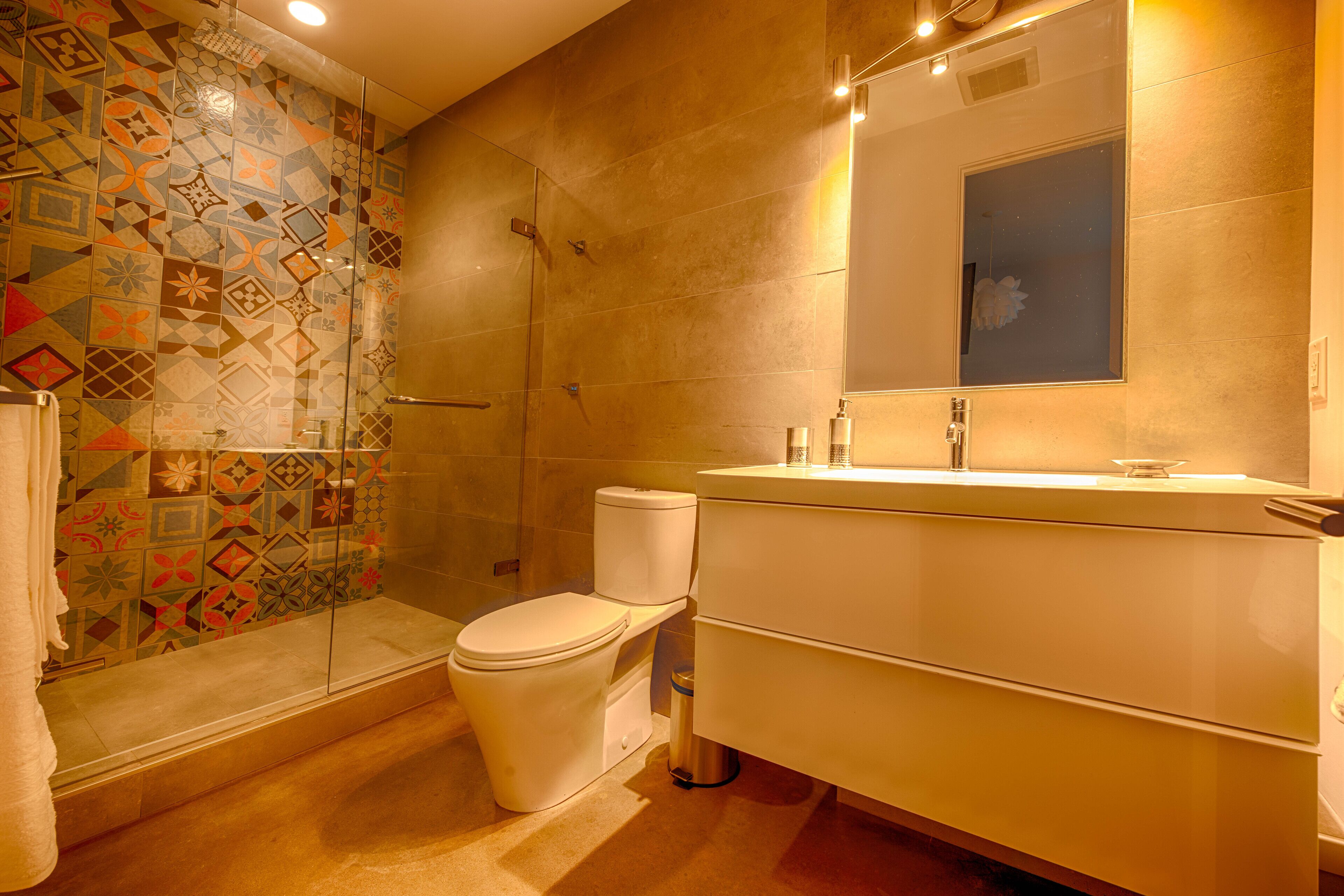 A bathroom with a shower, toilet, and sink.