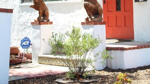 A white building with a red door and the number 2908. - Charming North Park house, with parking and new central Air.  (San Diego)