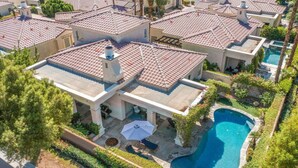 A residential area with multiple houses, a swimming pool, and a patio area. - Villa Puerta Azul · Backyard Oasis at Puerta Azul (La Quinta)
