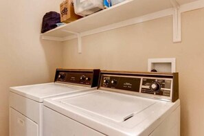 Convenient laundry facilities feature two front-loading washing machines with controls.