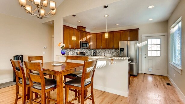 A modern kitchen with wooden cabinets, stainless steel appliances, and a central island. - 60 Minutes to Ski Country, 15 Minutes to Downtown Denver (Golden)