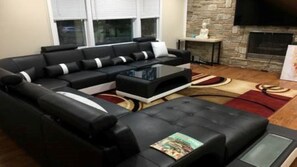 Relax in this stylish living room with a comfortable sofa, coffee table, and stone fireplace.