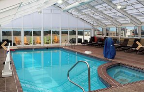 Relax by the pool with a view of the surrounding landscape through large windows.