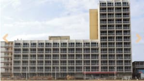 A large, multi-story building with a grid-like facade and balconies. - 1 Bedroom Studio on the Virginia Beach waterfront (Virginia Beach)