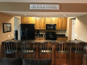 Microwave, dishwasher, coffee/tea maker, cookware/dishes/utensils