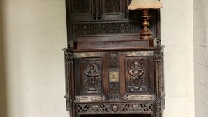 A dark wooden cabinet with intricate carvings and a lamp on top. - Authentic 13th century chateau, in 3 acres  surrounded by high stone walls. (Limoges)