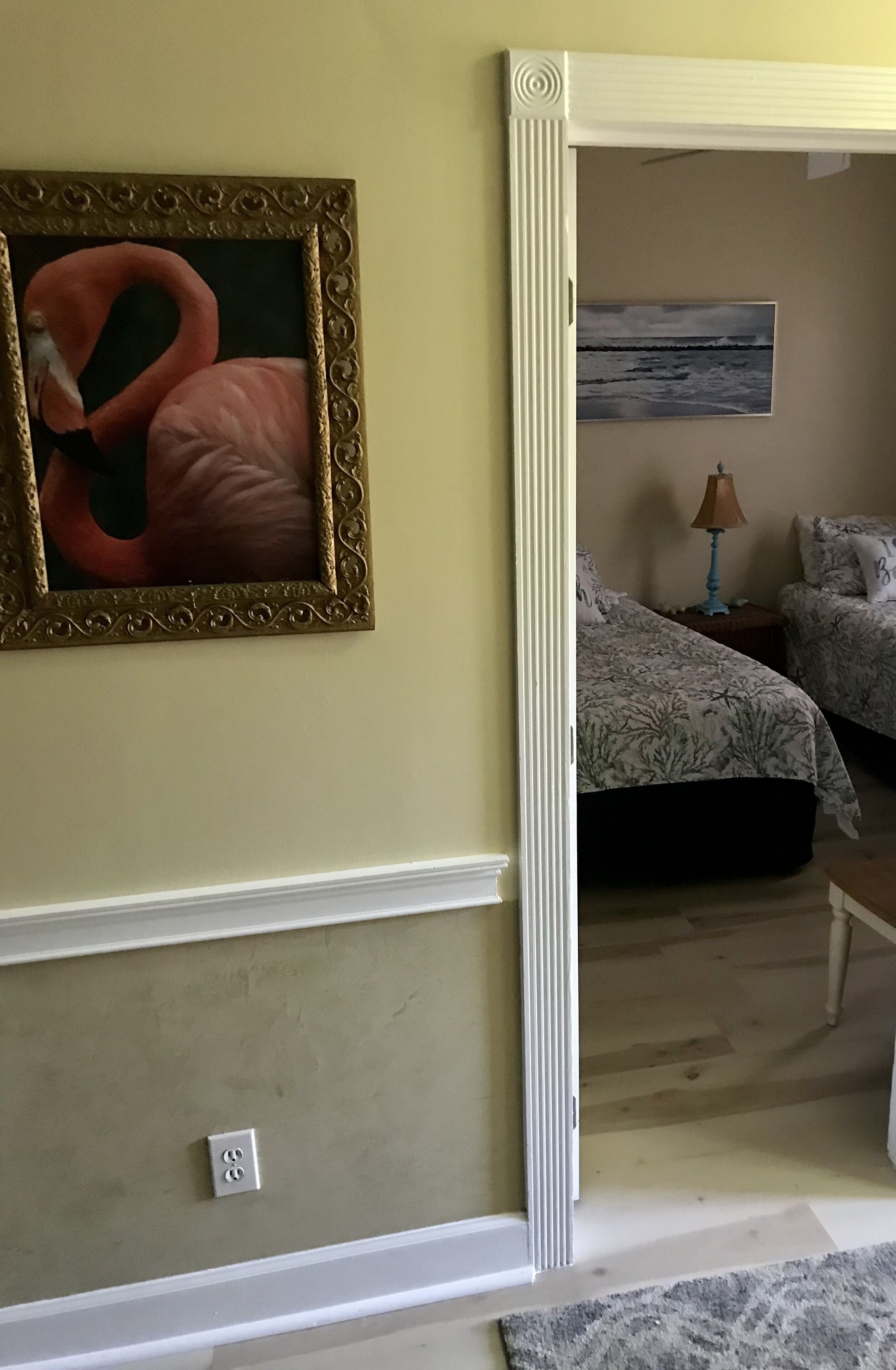 A room with a bed, a nightstand, and a lamp.