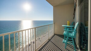 A balcony with a view of the ocean, a table, and two chairs. - Royal Beachfront Unit, Sleeps 6, Walk to Pier Park (Panama City Beach)