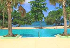 A pool area with a view of the beach and ocean. - Private Luxury Beachfront/Oceanfront Townhome in Beautiful Negril, Jamaica (Negril)
