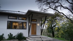 A modern two-story house with a flat roof, large windows, and a wooden door. - Wake Up in Your Own Private Vineyard - Healdsburg (Healdsburg)