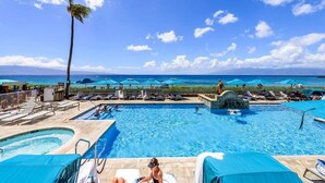 A pool area with multiple swimming pools, lounge chairs, and a view of the ocean. - BeachFront Luxury 1BR Excellent Views Pool-Whaler 859 (Lahaina)