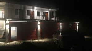 A two-story building with a car parked in front. - Mayumi Lodge, Perfect for couples. Cozy and Nice! Fast Internet (Puerto Princesa)