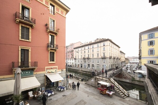 A street scene with buildings, outdoor seating, and a canal.