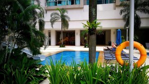 An indoor pool area with a clear view of the pool, lounge chairs, and a lifebuoy. - Elysees Suite Marc Residence KLCC (Kuala Lumpur)