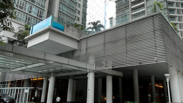A modern building with a covered entrance, large columns, and a parking area. - Elysees Suite Marc Residence KLCC (Kuala Lumpur)