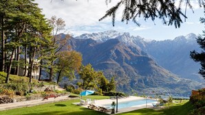A pool area with lounge chairs and a view of snow-capped mountains. - A Place That Stays With You - The Cloud House (bellagio)