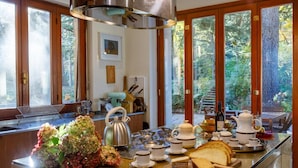A kitchen with a large island, equipped with a kettle, teapot, cups, and bread. - A Place That Stays With You - The Cloud House (bellagio)