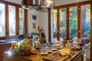 Enjoy a meal with a view from the kitchen's breakfast bar, overlooking a lush outdoor area.
