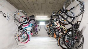 A bicycle storage area with multiple bikes parked in rows. - Stylish Apartment with Gym | 400 m to the Beach, Balcony (Kolobrzeg)