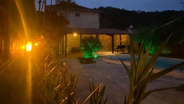 A house with a pool, surrounded by palm trees and a garden. - HOUSE WITH POOL CANTO DO FORTE, 10 people (Praia Grande)