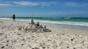A sandy beach with a large sandcastle and a person standing in the background. - LAST MINUTE DEALS! FREE WIFI I  Banyan – Peaceful 1BR Getaway Near Beaches, Bays & Dining (Bradenton)