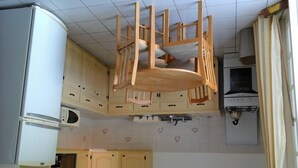 A compact kitchen with a microwave, stove, and wooden cabinets. - very spacious, neat and organized (Gros Islet)