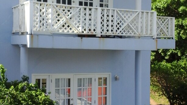 A two-story building with a balcony and a door. - very spacious, neat and organized (Gros Islet)