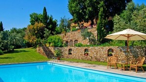 A swimming pool with stone walls and a stone staircase leading up to a building. - Villa Carmignani, your home in Tuscany: exlusive use of villa, grounds and pool. (San Casciano in Val di Pesa)