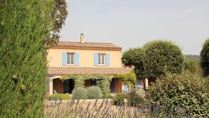 A two-story house with a tiled roof, blue shutters, and a covered porch. - Villa du Moulin with private swimming pool (Saumane de Vaucluse)