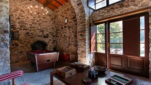 A rustic stone room with a pool table, wooden furniture, and a large window. - Fantastic family villa with pool.... (Barga)
