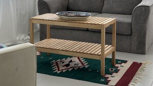 A living room with a grey sofa, a wooden coffee table with a decorative bowl, a patterned rug, and a white air conditioning unit in the background. - Surfside Beach, Texas. Fantastic views of the beach and bay. Steps to the beach (Freeport)