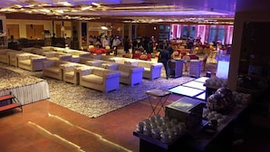 A spacious lobby with multiple seating areas, a reception desk, and a buffet table. - The Utsav Grand Banquets & Resort (Sonepat)