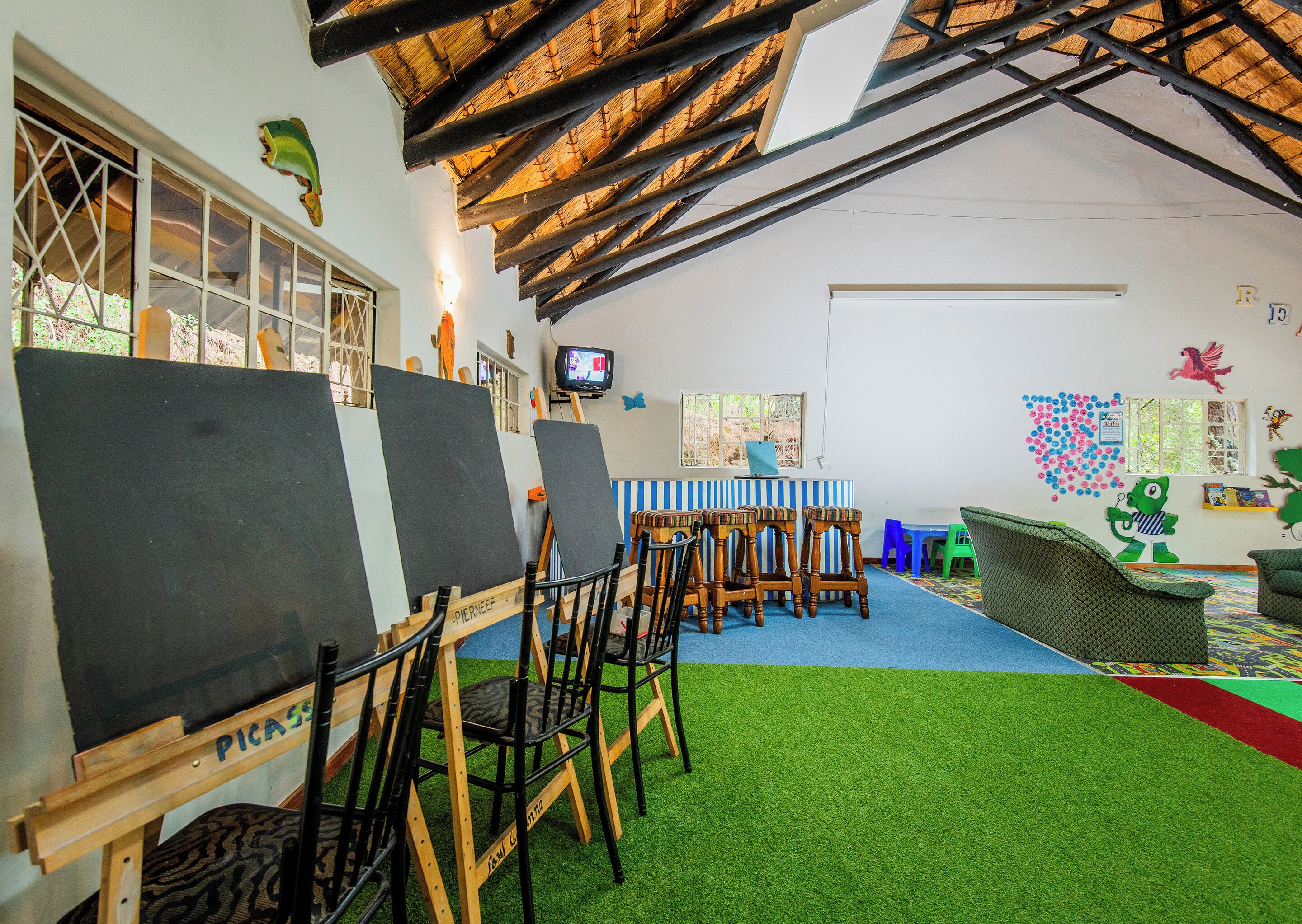 An art studio with easels, a television, and colorful decorations.