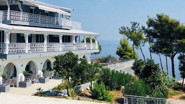 A large, multi-story building with balconies, a pool area, and a view of the sea. - Aelia Sea View Studios (Kassandra)