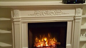 A fireplace with a TV mounted above it. - Beautiful Colonial Mint Condition Summer House Walking Distance to Beach (Laurel)