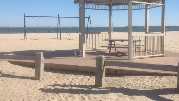 A beach gazebo with a metal roof, a bench, and a swing set. - Beautiful Colonial Mint Condition Summer House Walking Distance to Beach (Laurel)