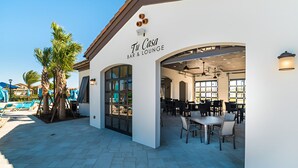 A restaurant named 'Till Casa Bar & Lounge' with outdoor seating and a pool in the background.